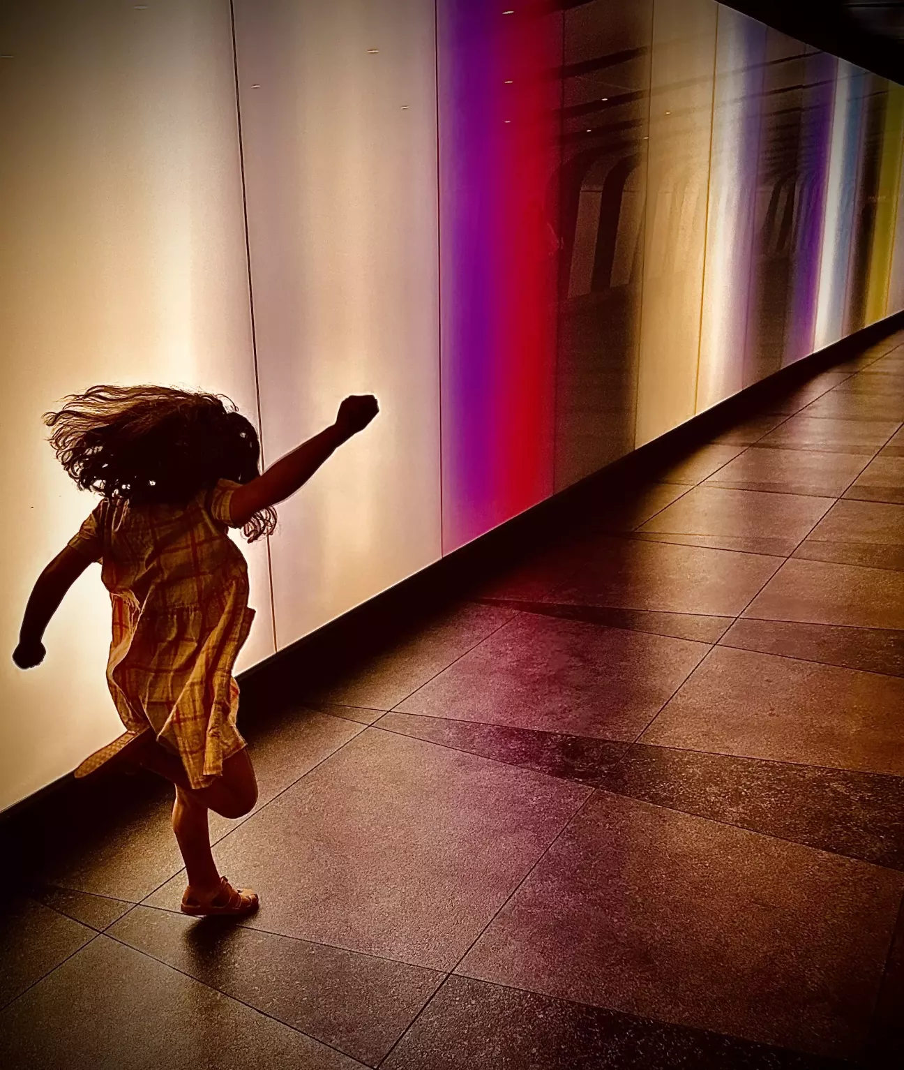 Running child against backlit background